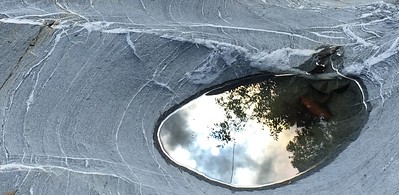 The sky and nature reflecting on a pool of water