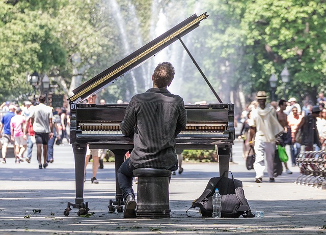 piano player in a park with a grand piano